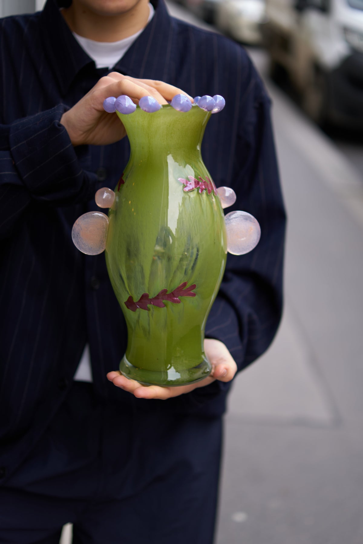 A unique blown-glass vase by Roksolana Hudoba, created through a process that begins with hand-drawn sketches and culminates in the transformation of molten glass into a refined decorative object. Classical forms are reinterpreted through subtle accents and contemporary proportions, resulting in a piece that feels both familiar and distinctly modern.